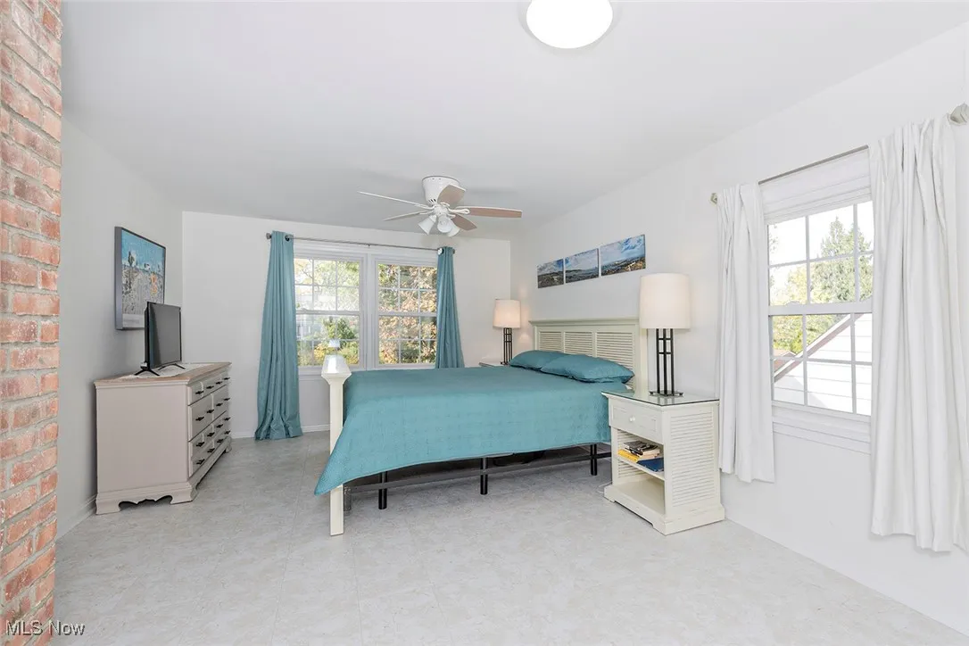 Bedroom with multiple windows and ceiling fan