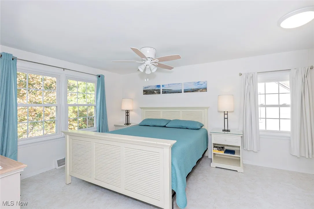 Bedroom featuring a ceiling fan and baseboards