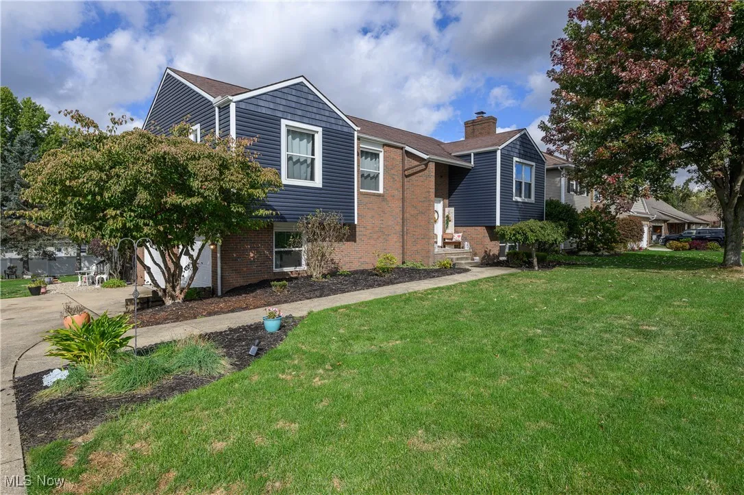 View of front of property featuring brick siding and a front yard