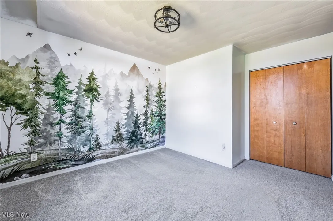 Unfurnished bedroom with carpet floors and a closet