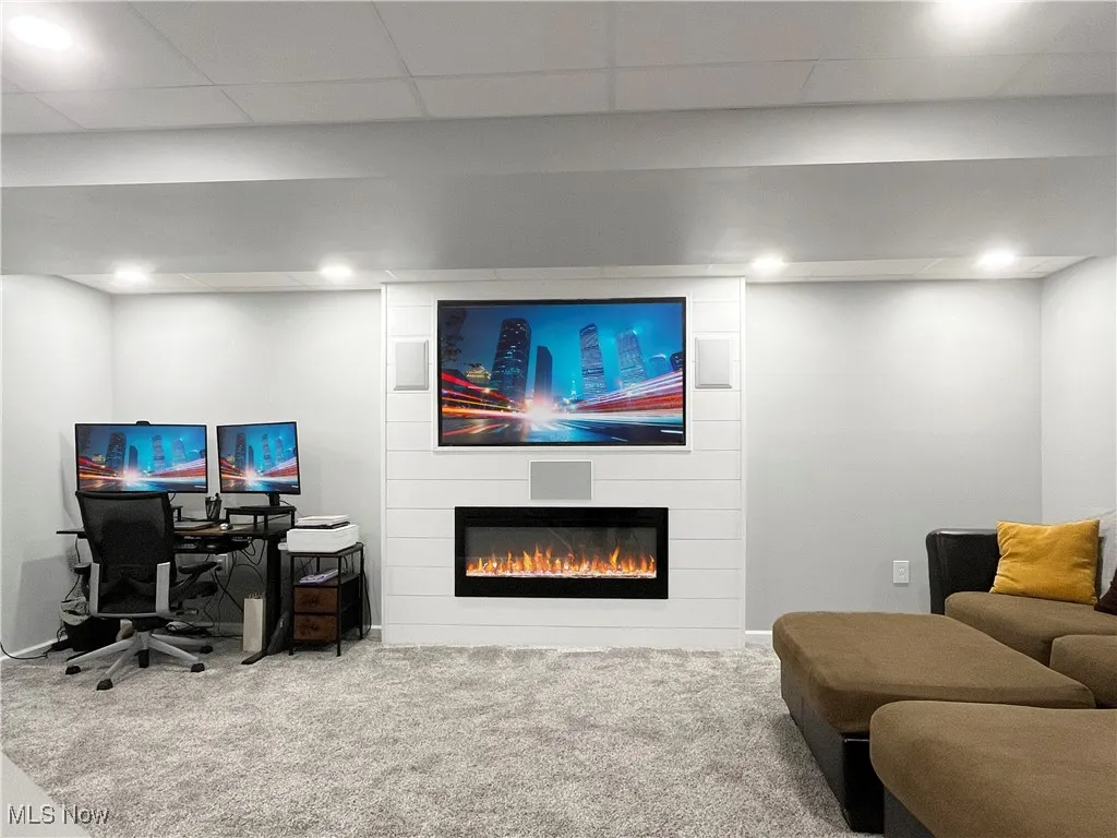Carpeted home office with a large fireplace, recessed lighting, and a paneled ceiling