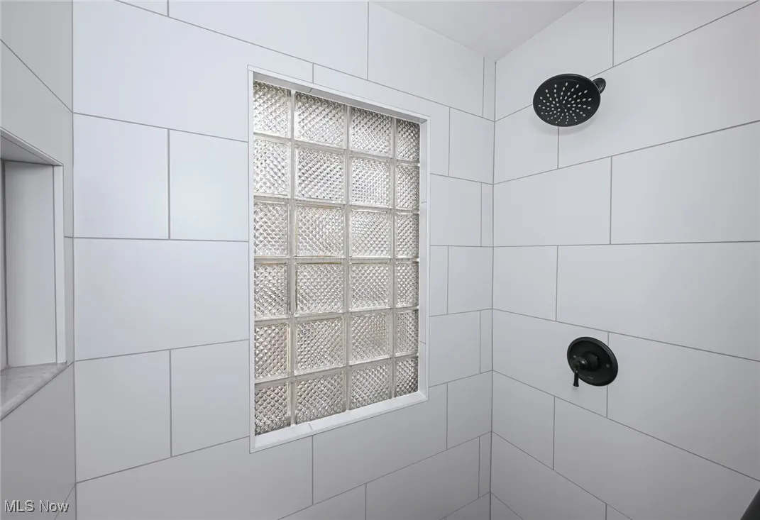 Bathroom view of tiled shower and elevator