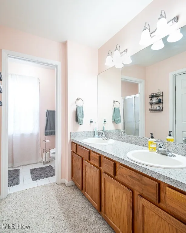 Bathroom with double vanity, a shower stall.