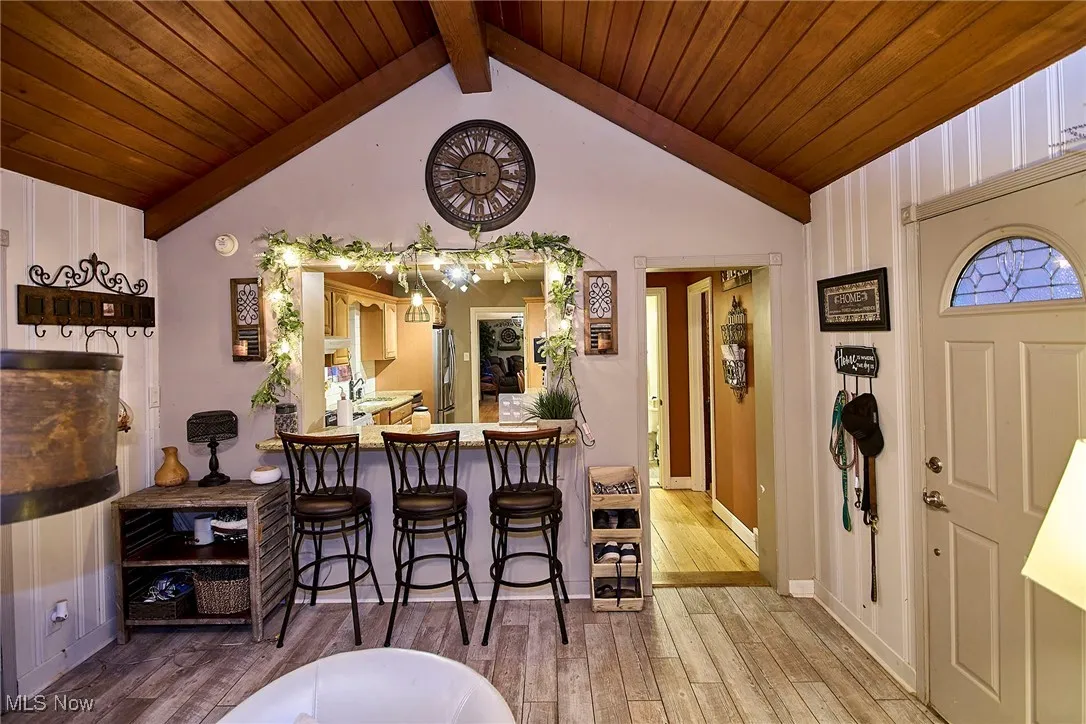 Dining room with light wood finished floors and wooden ceiling