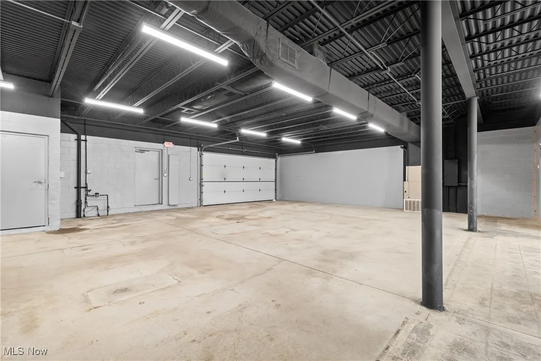 Garage featuring concrete block wall