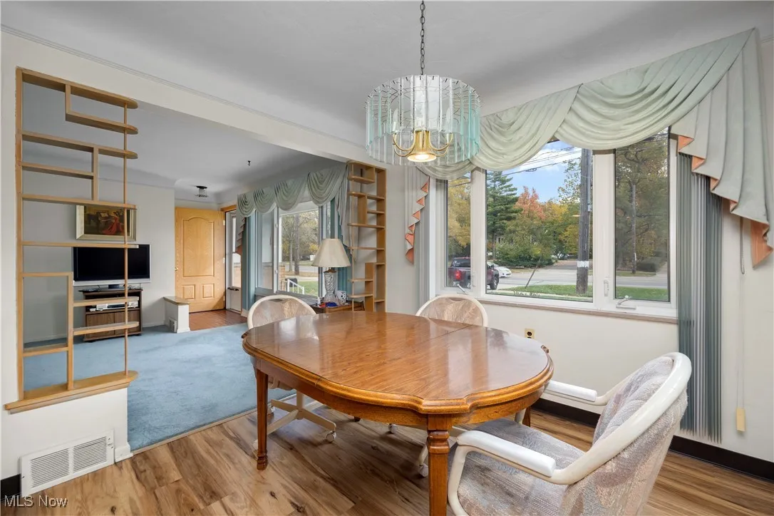 Dining area with laminate finished floors and a chandelier