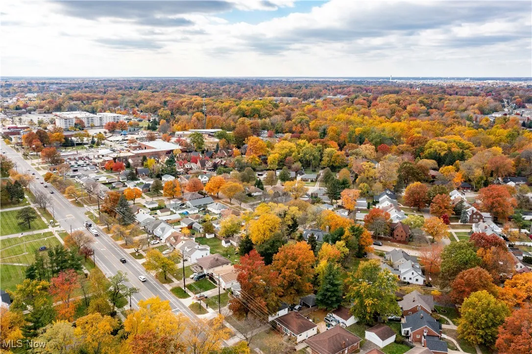 Aerial view of home showing more of surrounding neighborhood
