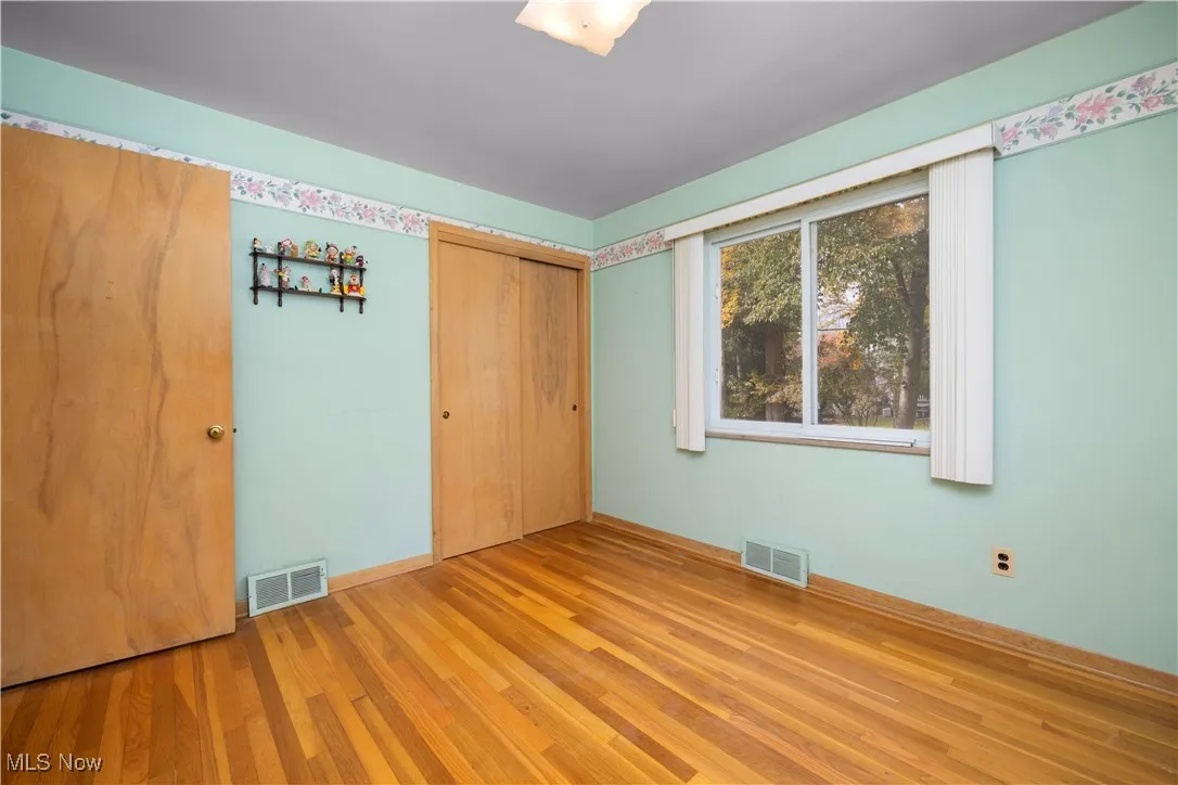 Bedroom with light hardwood flooring
