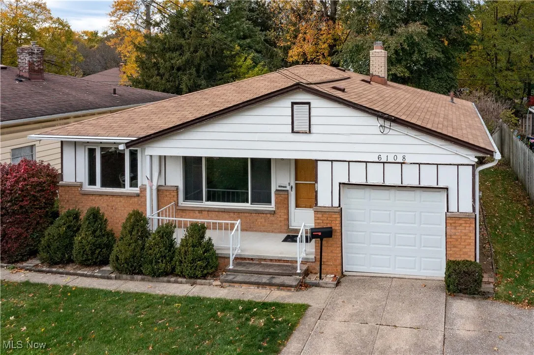 Single story home featuring a porch, brick siding, a one attached garage
