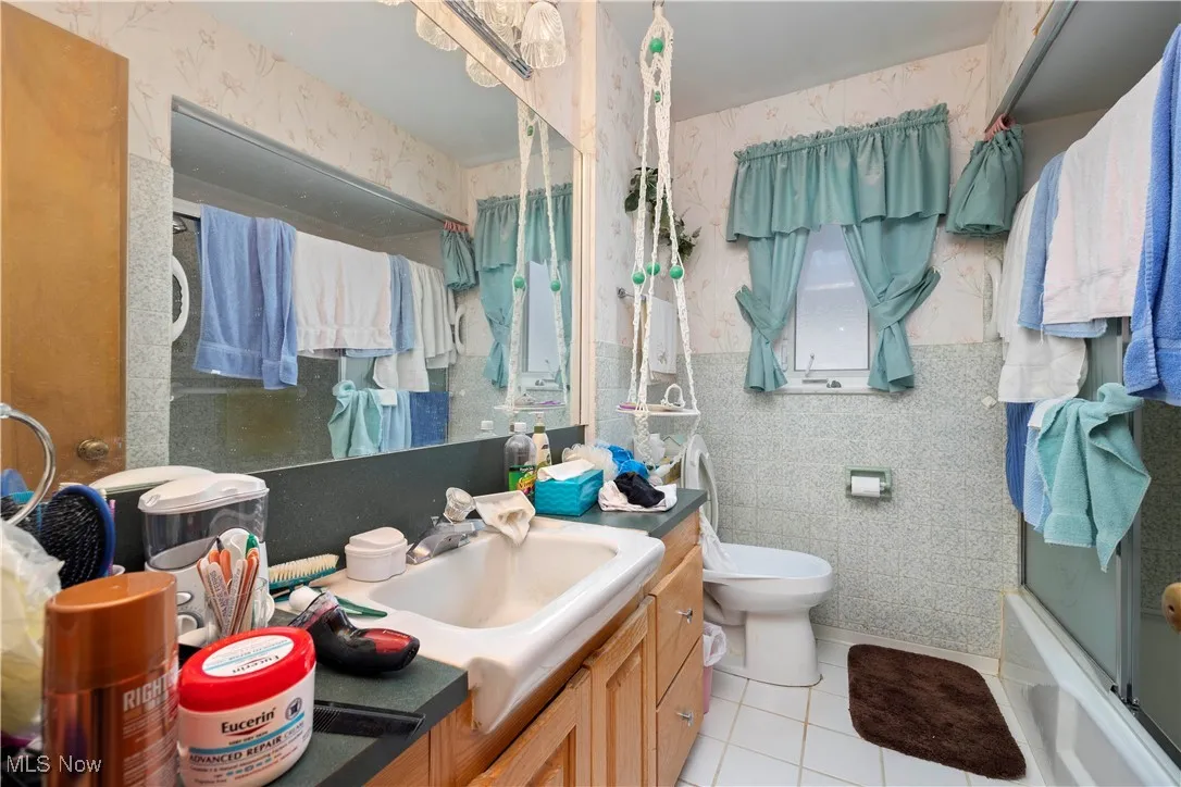 Bathroom with ceramic flooring on main level
