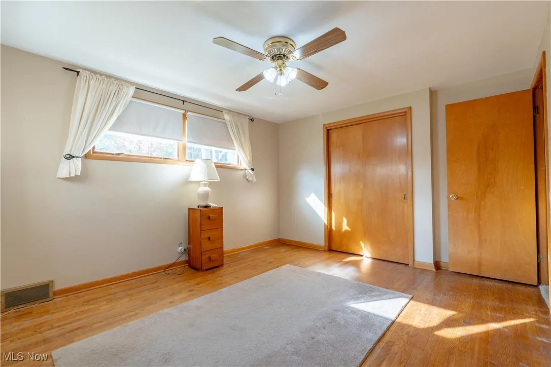 Unfurnished bedroom with light wood-type flooring, a closet, and ceiling fan