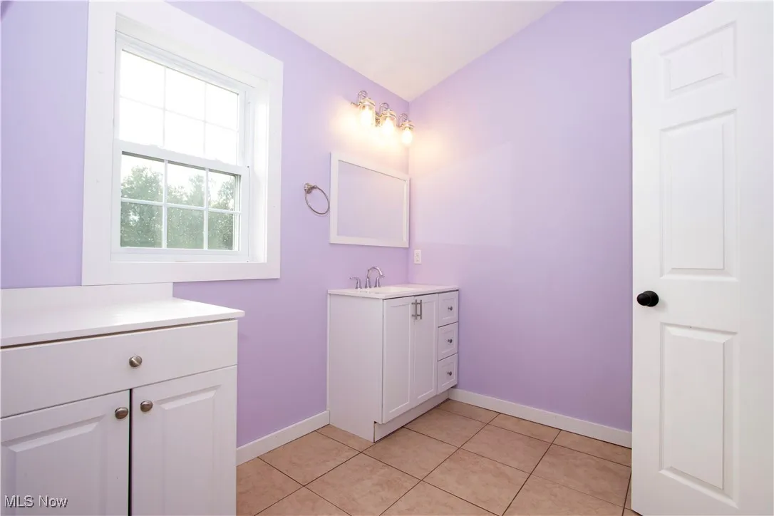 Bathroom with vanity and light tile patterned floors