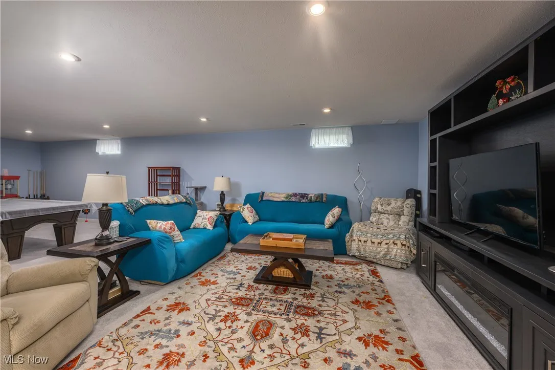 Living area featuring light carpet and recessed lighting