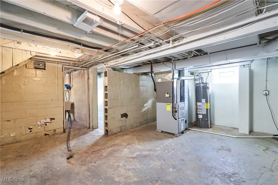 Below grade area with gas water heater and heating unit