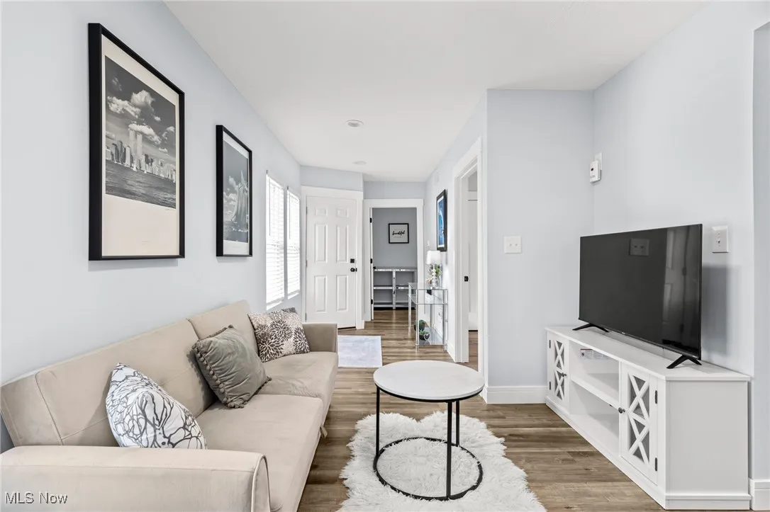 Living area with light wood-style floors and baseboards