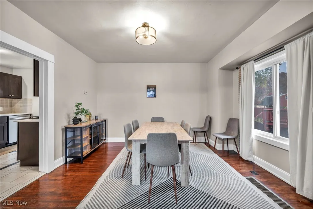 Dining space featuring dark wood-style flooring