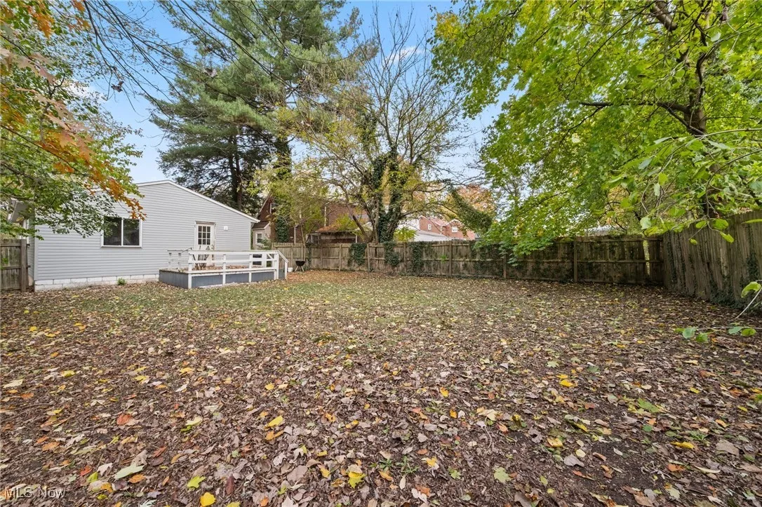 Fenced backyard with a wooden deck