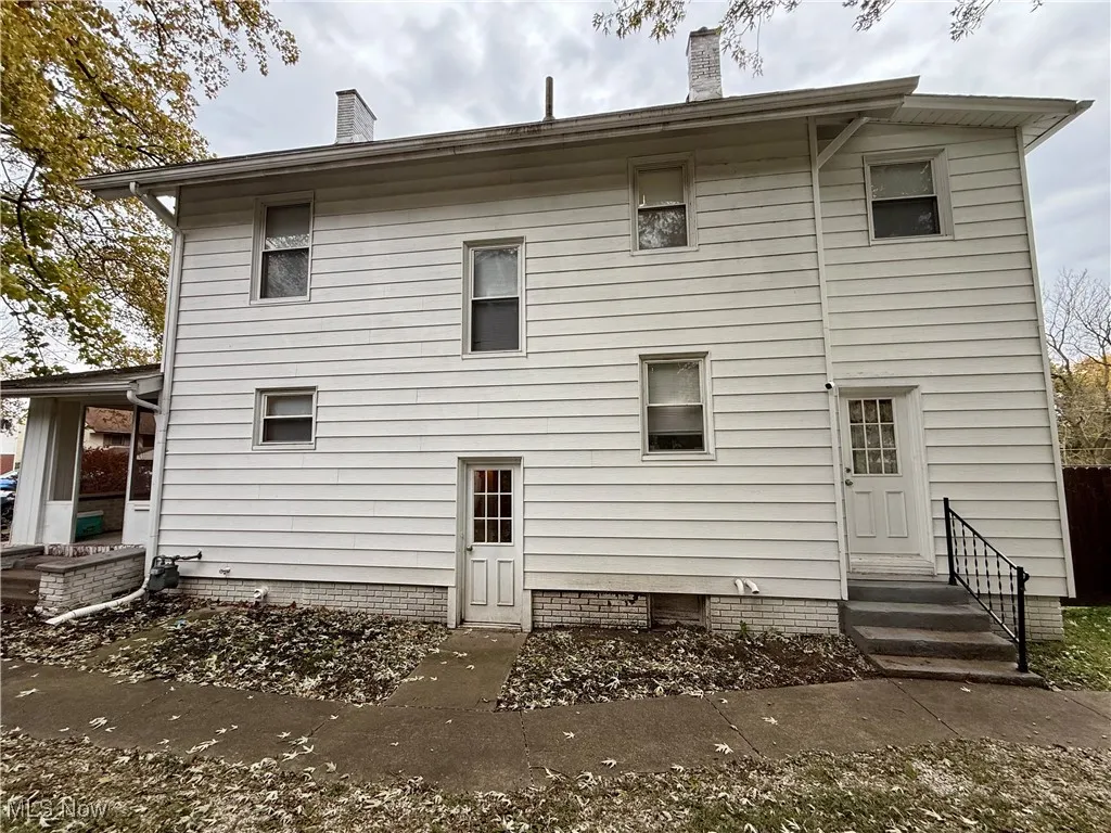 Rear view of house with a chimney
