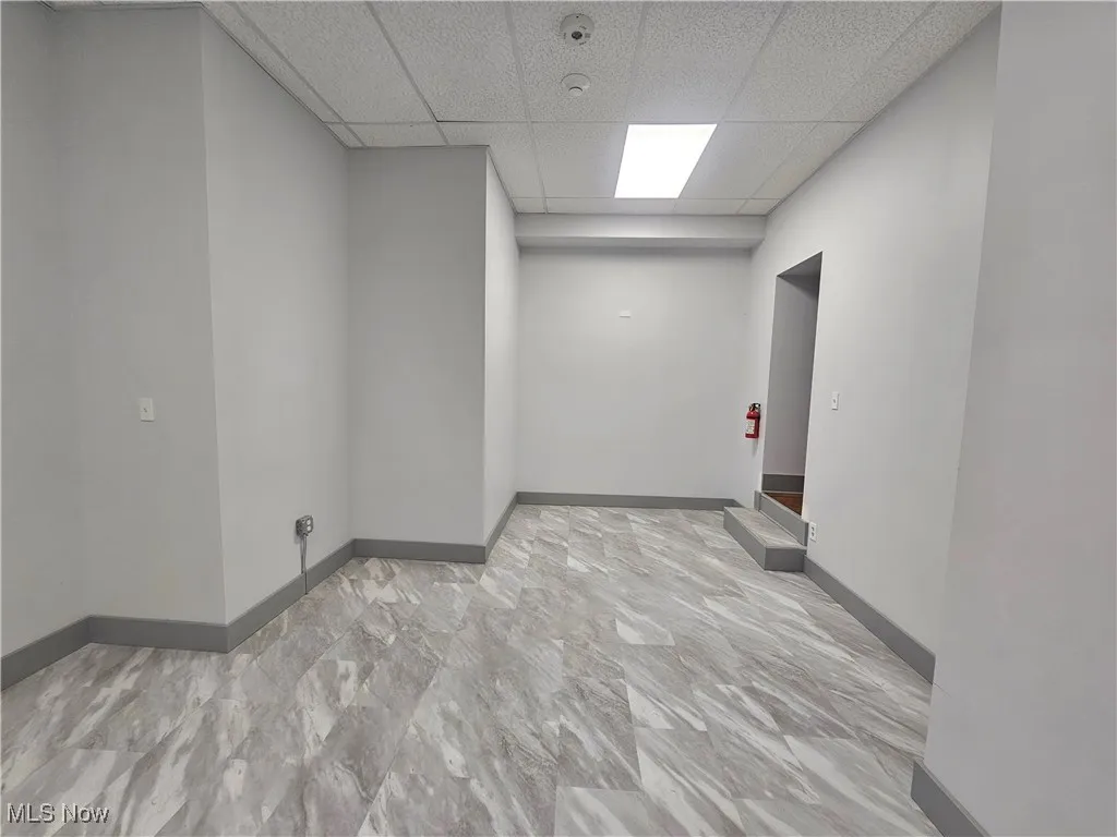 Basement featuring a chandelier and light parquet flooring
