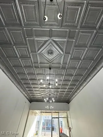 Unfurnished room featuring a drop ceiling and dark wood finished floors