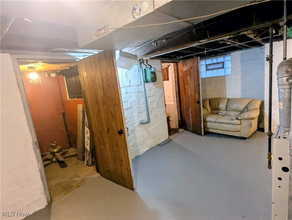 Basement featuring gas meter and additional storage rooms