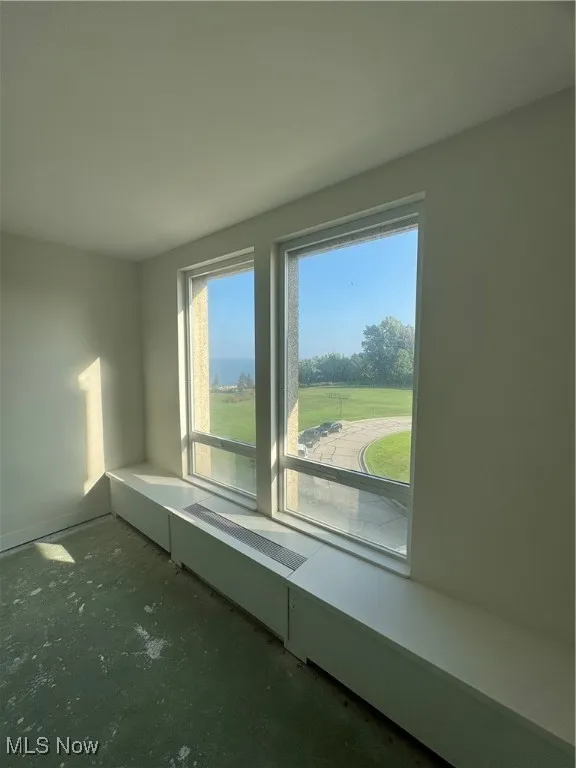Unfurnished room featuring unfinished concrete floors