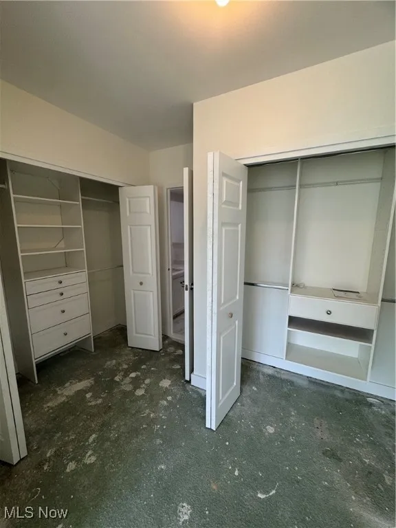 Unfurnished bedroom with multiple closets
