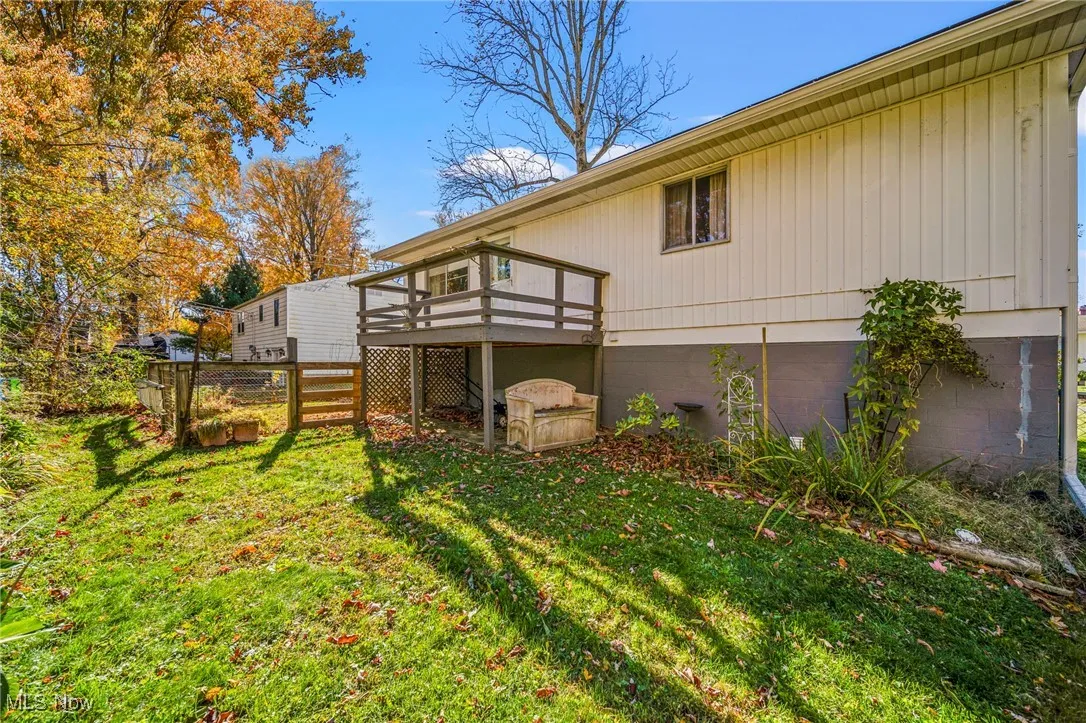 Fenced backyard with a wooden deck