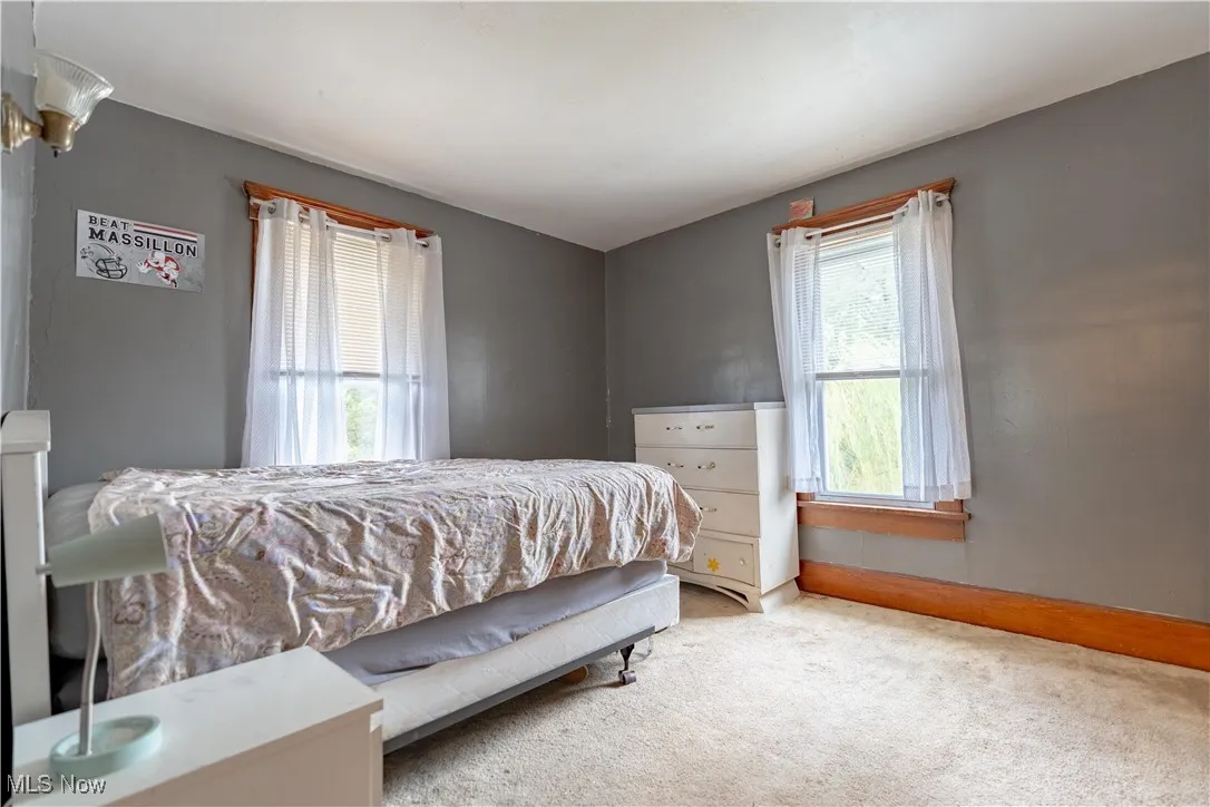 Bedroom with carpet flooring and baseboards