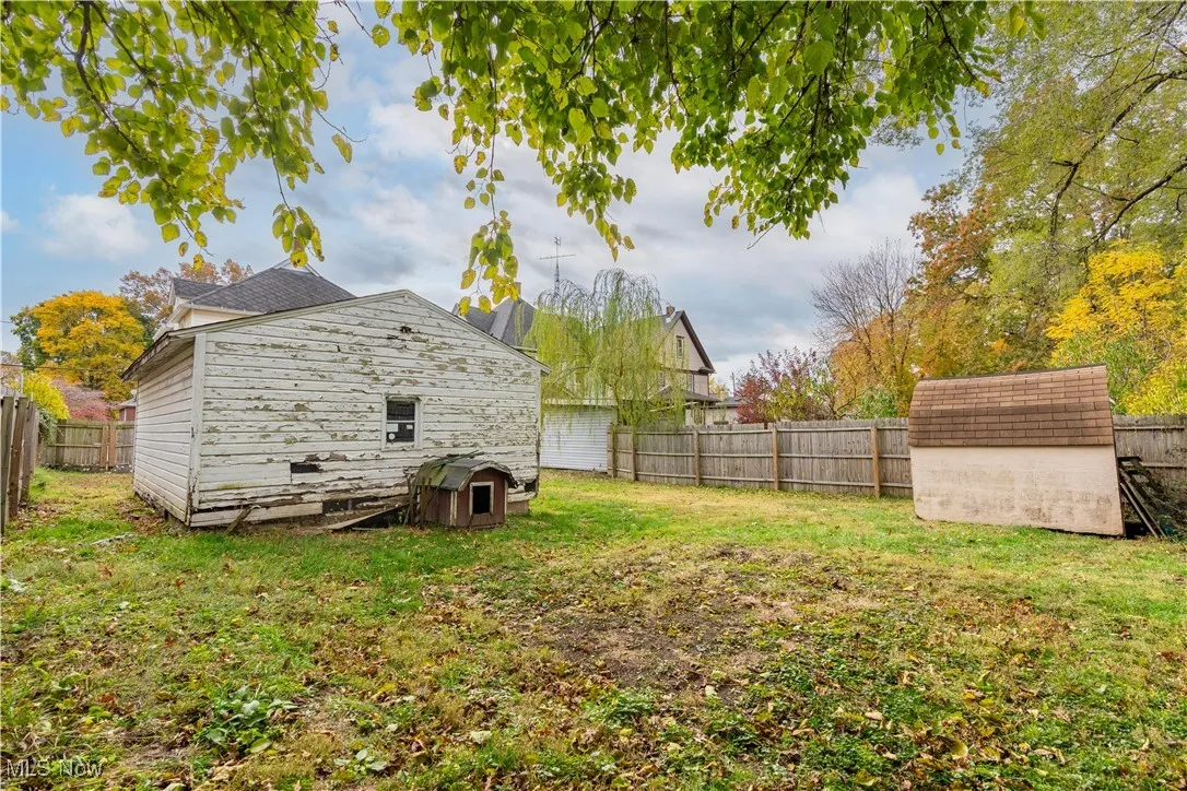 Fenced backyard with a storage unit