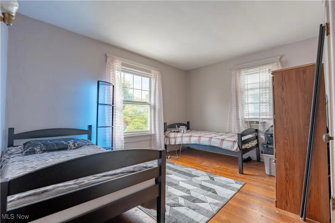 Bedroom featuring light wood finished floors and multiple windows