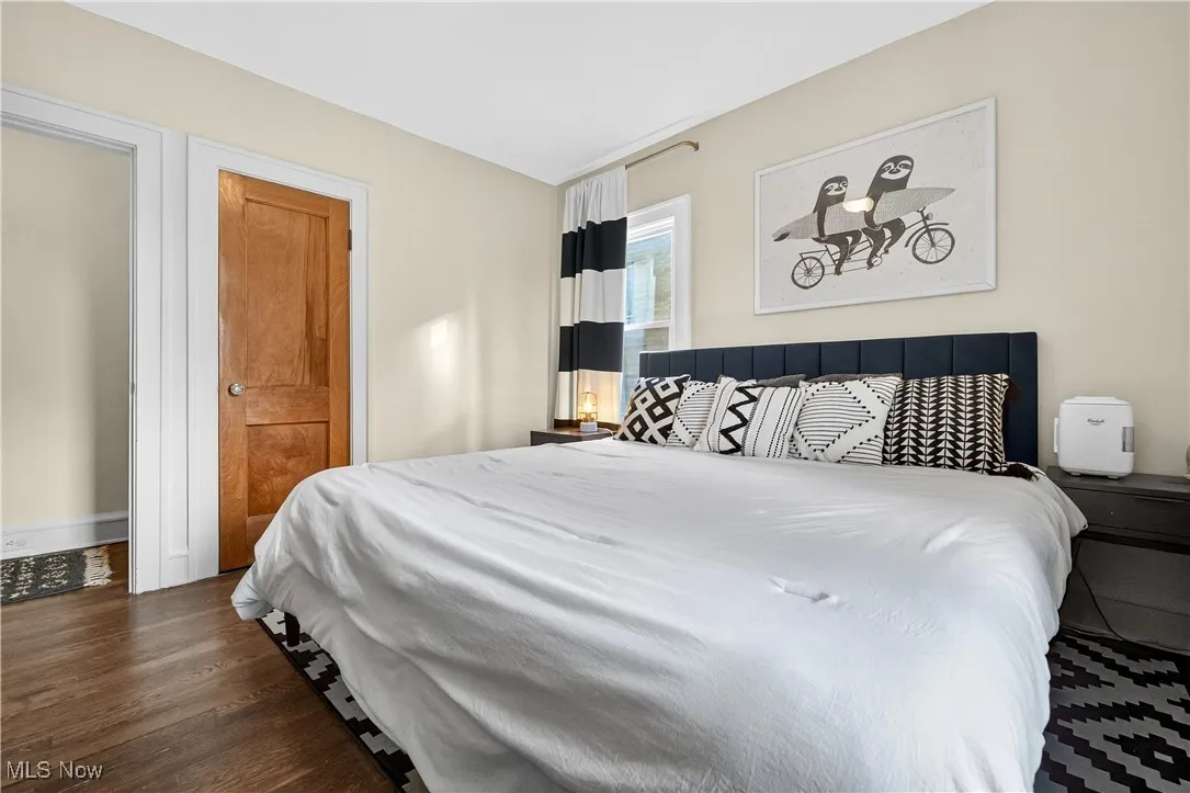 Bedroom with dark wood-style flooring