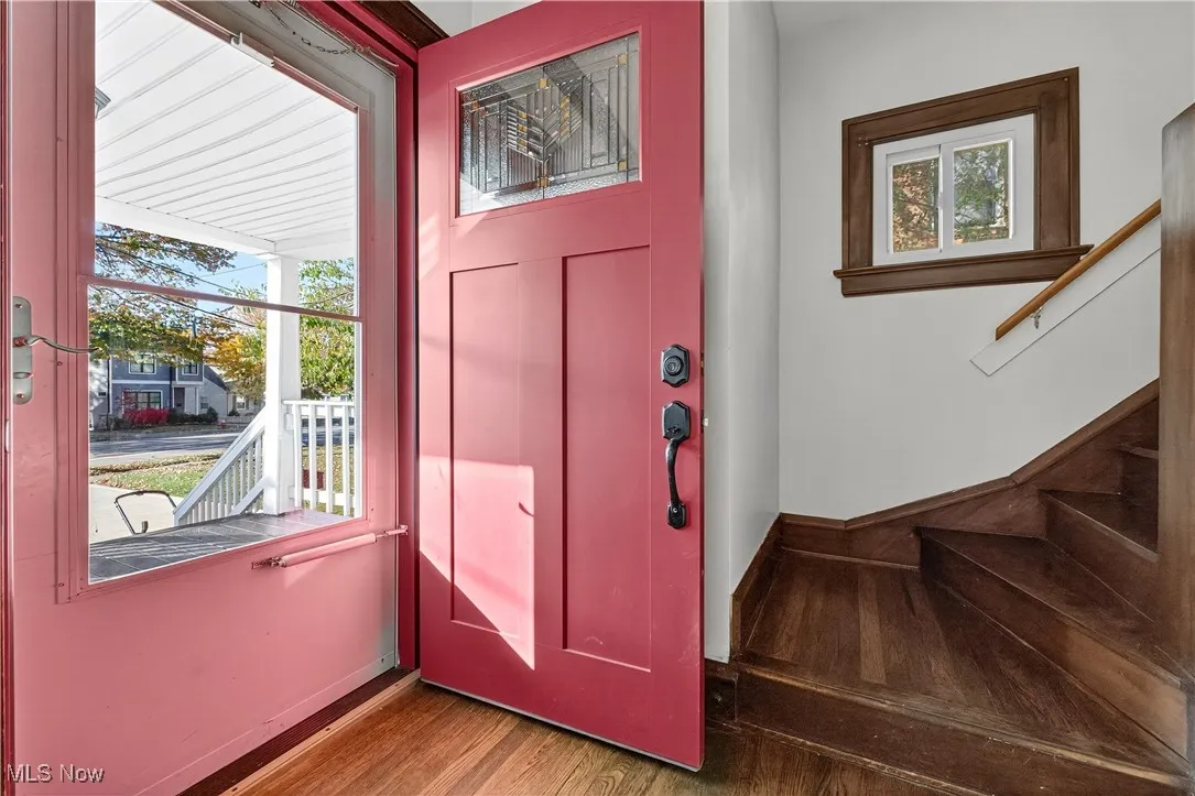 Foyer featuring stairs and dark wood-style floors