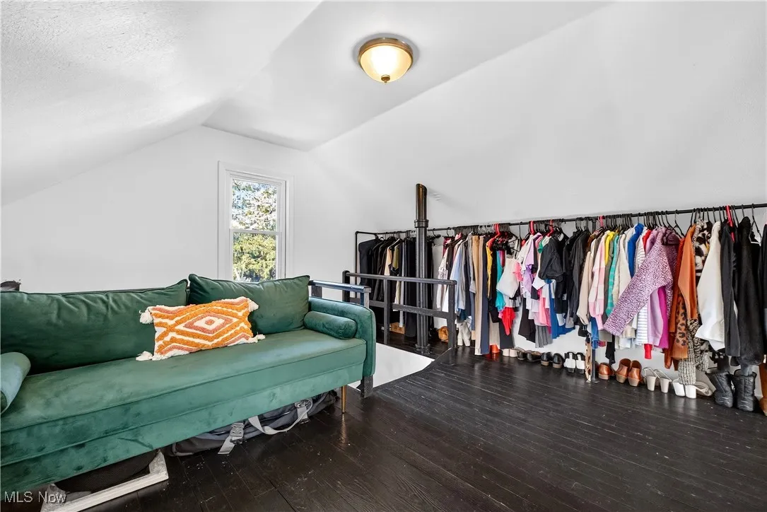 Living area with lofted ceiling and hardwood / wood-style flooring