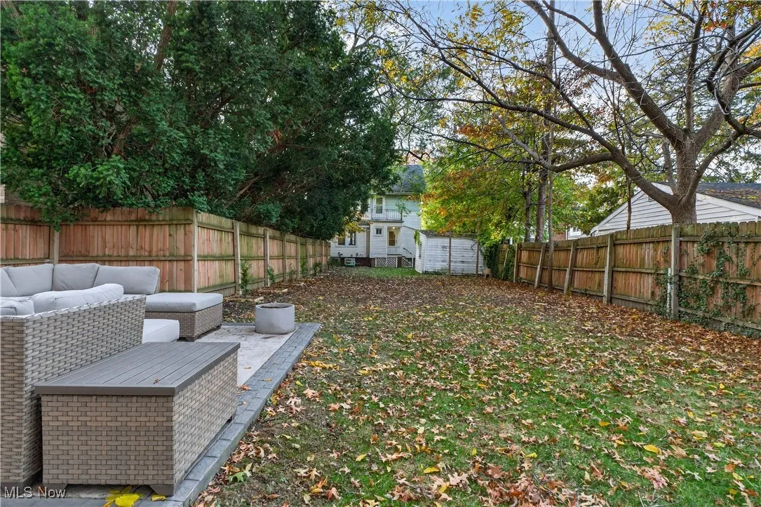 Fenced backyard with outdoor lounge area