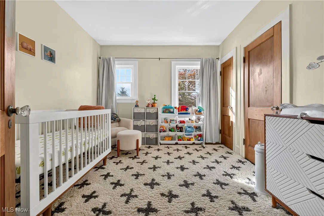 Bedroom with carpet flooring and a nursery area