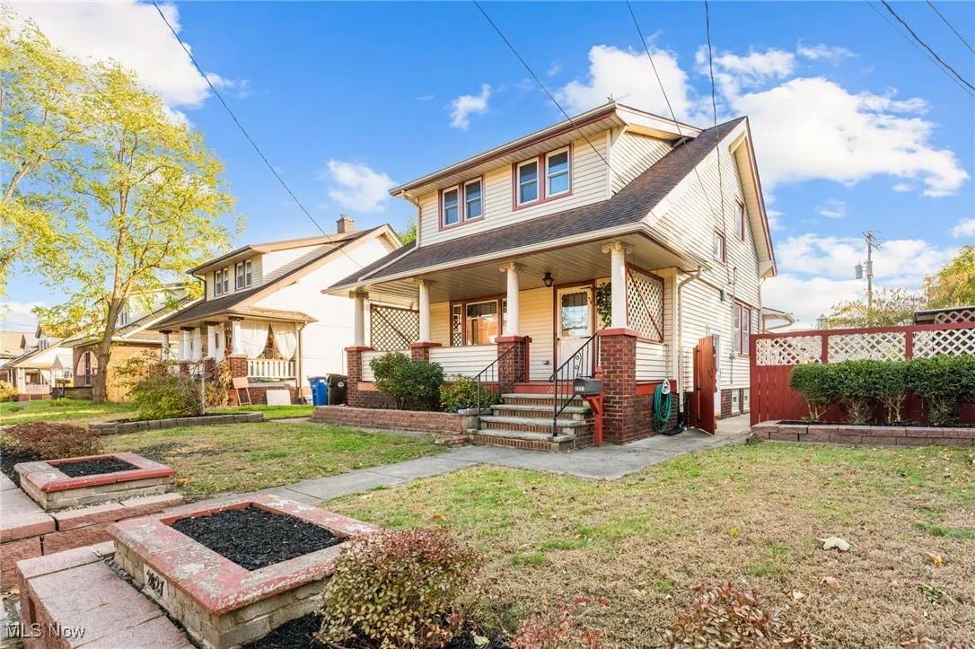 View of front of home featuring a porch, roof with shingles, and a fire pit