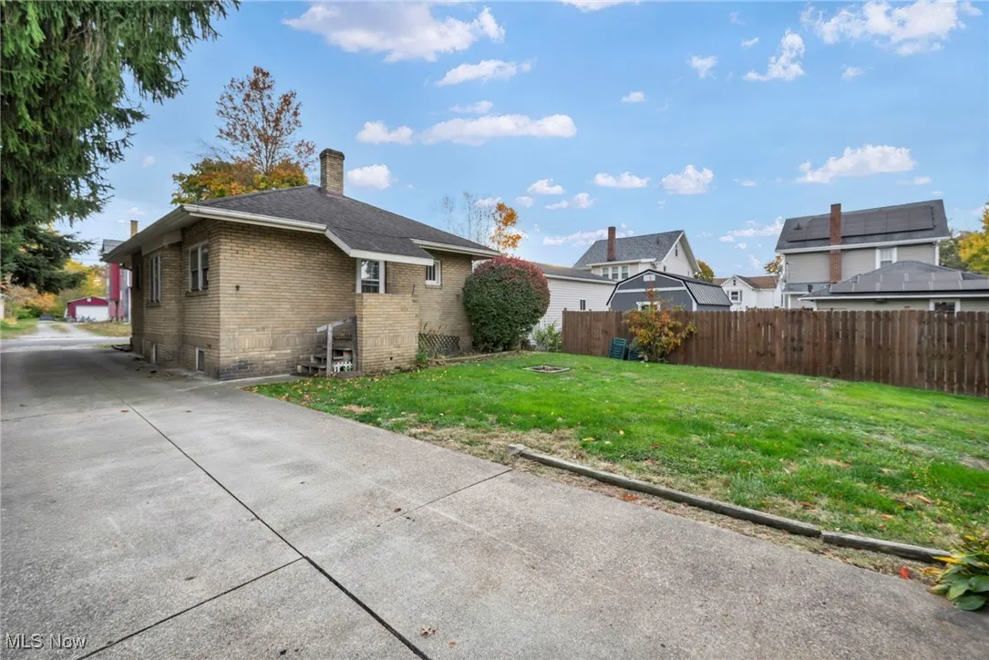 Back of property featuring brick siding and a chimney