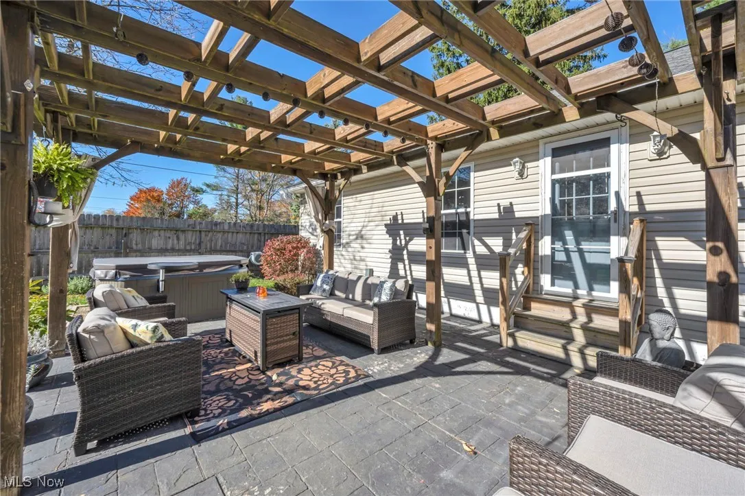 View of patio / terrace with outdoor lounge area, a hot tub, and a pergola