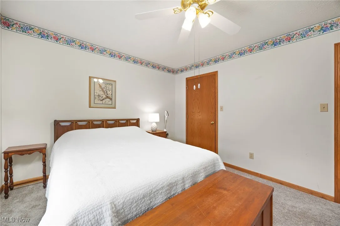 Bedroom featuring light carpet and a ceiling fan