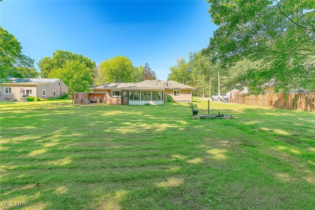 Back of property with a sunroom