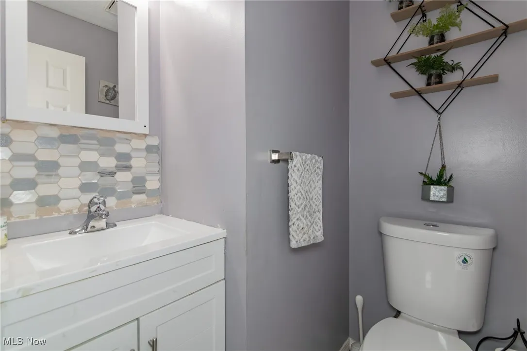 Bathroom with decorative backsplash and vanity