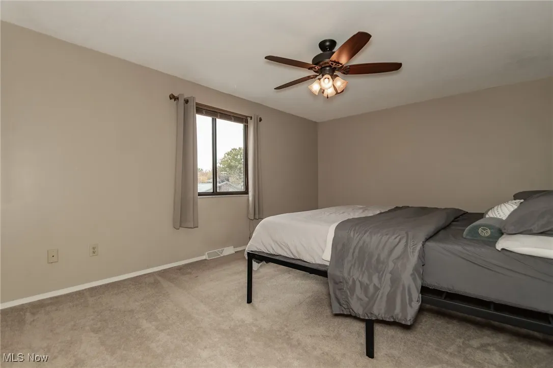 Bedroom with carpet floors and a ceiling fan
