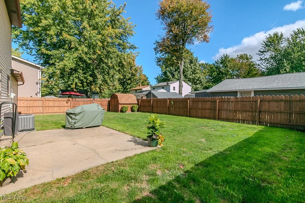 Fenced backyard with a patio