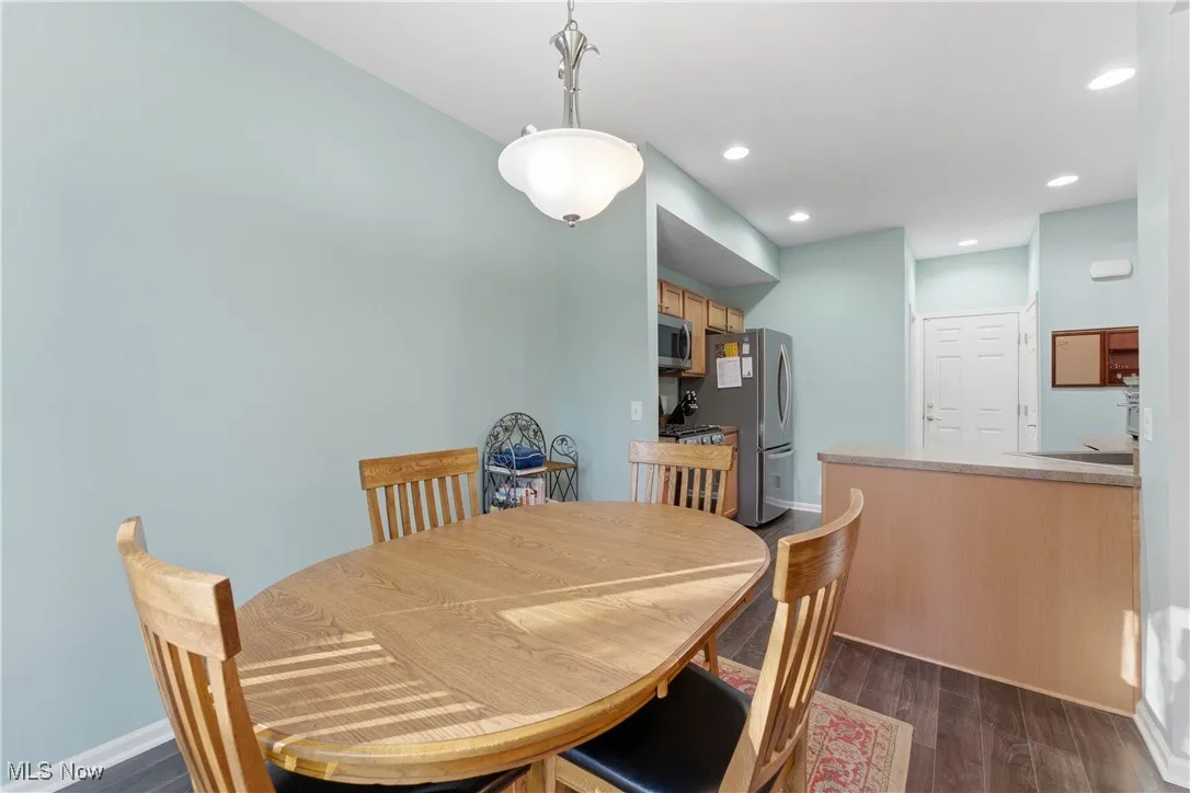 Dining room featuring dark wood-type flooring and recessed lighting