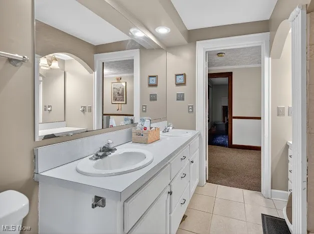 Full bathroom featuring light tile patterned floors, double vanity, light carpet, and recessed lighting