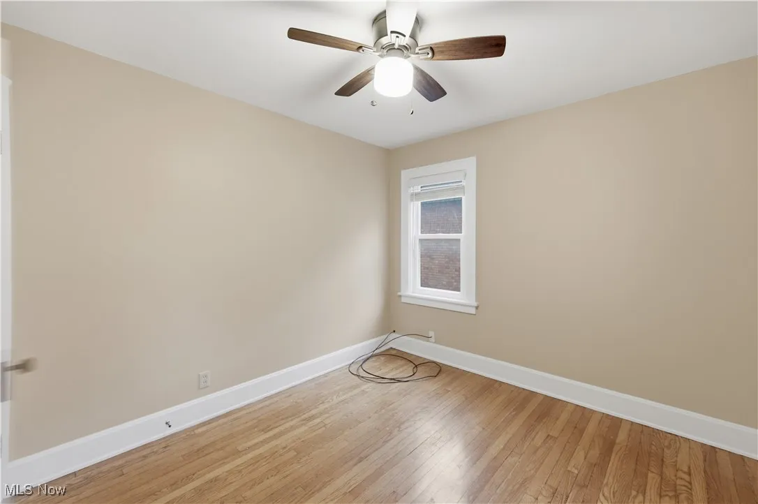 Unfurnished room with wood-type flooring and a ceiling fan