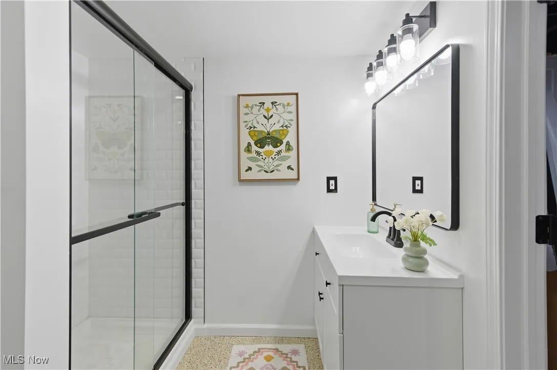 Bathroom featuring vanity and a stall shower