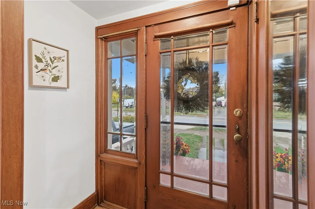 Entryway with baseboards and wood finished floors