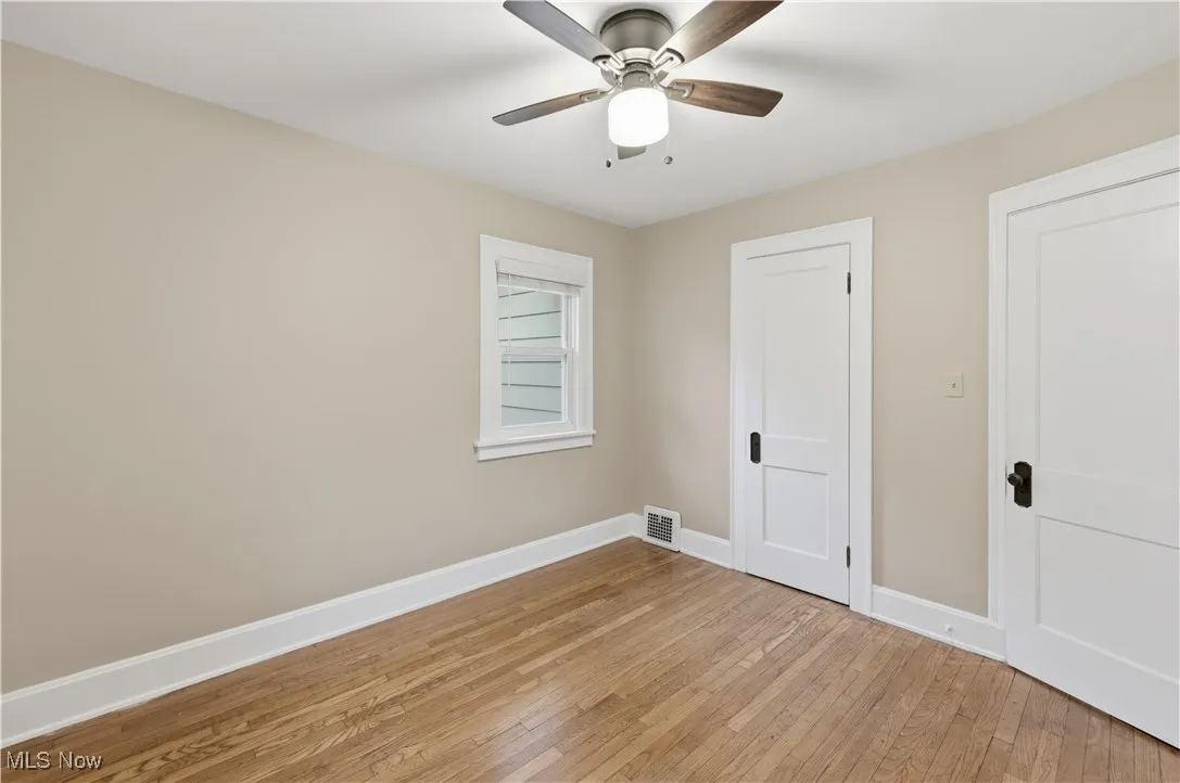 Unfurnished room with hardwood / wood-style flooring and a ceiling fan